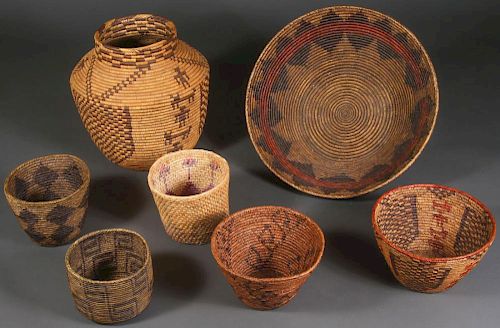 A GROUP OF SEVEN LARGE WOVEN BASKETS