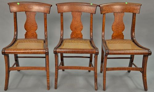 Set of three tiger maple cane seat chairs, circa 1840.