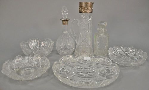 Group of seven pieces of cut glass to include tall pitcher with sterling top (ht. 13 1/4in.), larger charger (dia. 13in.), th