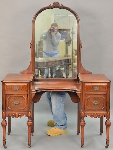 Two piece lot to include a mahogany vanity with mirror ht. 67in., wd. 49 1/2in. and a Chippendale style wing chair.  Provenan