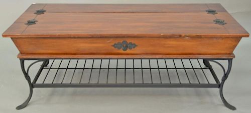 Coffee table with lift tops and iron base. ht. 19 in., top: 29" x 52"  Provenance: Property from the Estate of Frank Perrotti