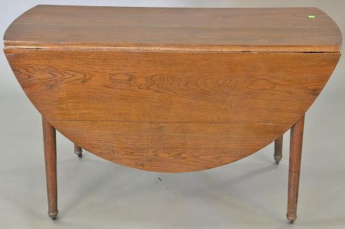 Oak drop leaf table. ht. 27 in., top closed: 21" x 54"   Provenance: The Estate of Thomas F Hodgman of Fairfield, Connecticut
