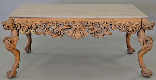 Hardwood Chinese table having granite top over carved apron and carved foo dog legs, ht. 28in., top: 31" x 58"  Provenance: F