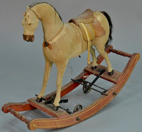 Rocking horse with wheels, hyde covered (seam splitting). 
height 26 inches
