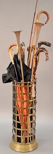 Brass umbrella holder (ht. 24in.) with canes and umbrellas, two copper horns, one silver handled umbrella mounted with stones