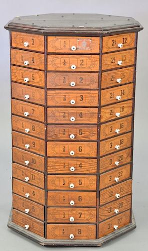 Octagon revolving cabinet with twelve drawers on each side. ht. 40 in., dia. 24 1/2 in.  Provenance: From the Estate of Faith