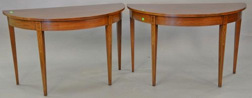 Pair of mahogany half round demilune tables. ht. 29 in., wd. 47 in.