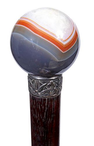 17. Agate Dress Cane-  Ca. 1920- A multicolored round agate handle, ornate metal collar, hardwood shaft and a horn ferrule.