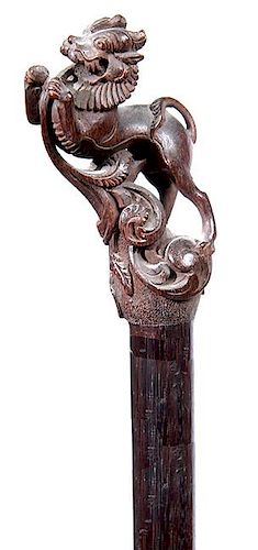 32. Foo Dog Dress Cane-  Ca. 1900- A nicely carved foo dog or some may call it a lion, silver metal collar, mahogany shaft