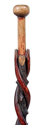 38. Folk Art Snake Cane-  Ca. 1880- A polychrome twin snake cane carved on a natural grown twigspur shaft, a heart and a ca