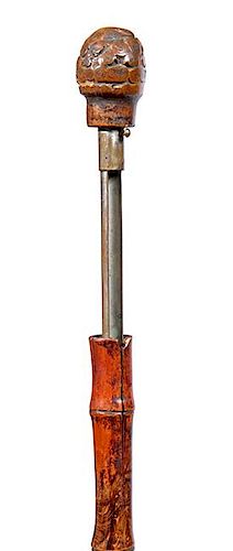 7. Cigarette System Stick-  Ca. 1900- A split bamboo container cane with a push mechanism, root handle and metal ferrule. H