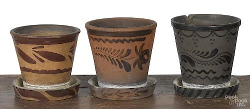 Three stoneware and tanware flowerpots