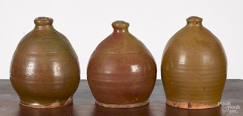 Three New England redware jugs