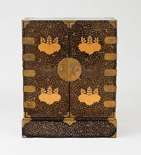 JAPANESE GILT-METAL-MOUNTED BLACK LACQUER AND PARCEL-GILT CABINET ON STAND