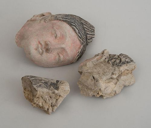 TWO GANDHARAN CLAY HEADS, ONE OF A FOREIGNER, THE OTHER OF A WOMAN