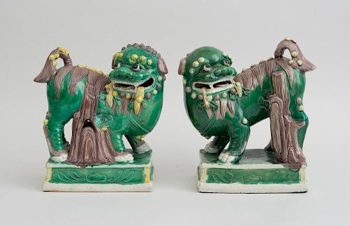 PAIR OF CHINESE MING STYLE GREEN, AUBERGINE AND YELLOW-GLAZED PORCELAIN BUDDHISTIC LIONS