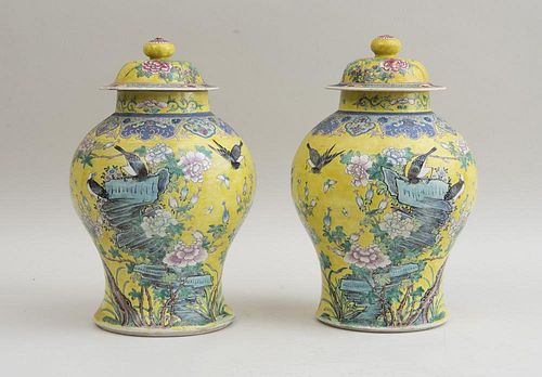 PAIR OF CHINESE YELLOW-GROUND FAMILLE ROSE PORCELAIN BALUSTER-FORM JARS AND COVERS