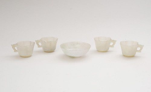 SET OF FOUR CHINESE SMOKEY GREY JADE HEXAFOIL CUPS AND A PALE JADEITE FOOTED DISH