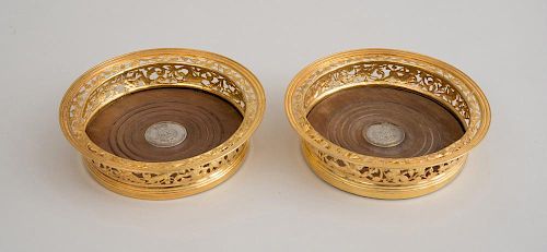 PAIR OF GEORGE IV SILVER-GILT BOTTLE COASTERS