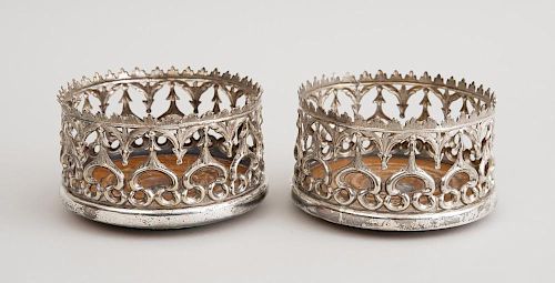 PAIR OF VICTORIAN GOTHIC REVIVAL SILVER-PLATED BOTTLE COASTERS