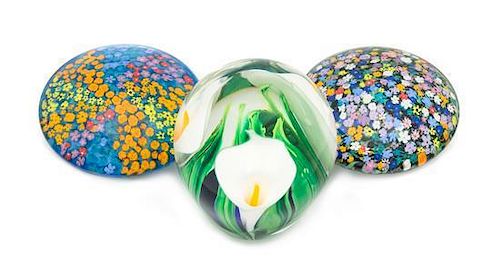 * Peter Raos, (American), three glass paperweights, each with floral decoration