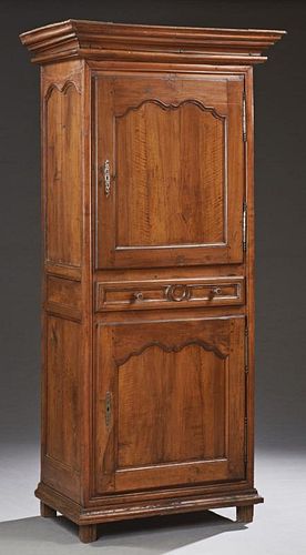 French Louis XV Style Carved Walnut Homme Debout, late 18th c., the stepped crown over a cupboard door with a long steel escu