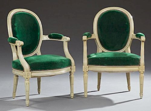 Pair of French Louis XVI Style Polychromed Beech Fauteuils, early 20th c., the upholstered medallion back within upholstered 