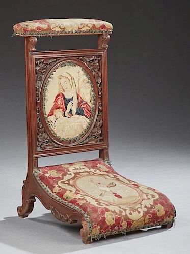 French Carved Walnut Prie Dieu, 19th c., with original needlework upholstery with iron tack decoration, the cushioned needlew