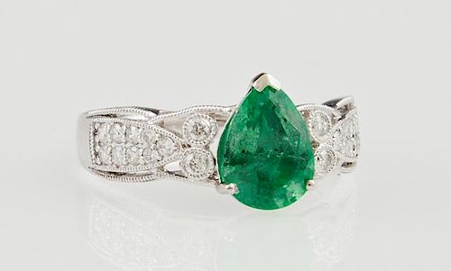 Lady's Platinum Dinner Ring, with a pear shaped 1.46 carat emerald, flanked by pierced diamond mounted shoulders, total diamo