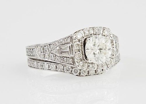 Lady's 14K White Gold Wedding Set, the engagement ring with a one carat round diamond atop a border of round diamonds, above 