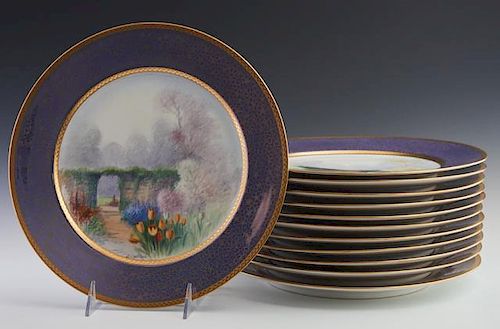 Set of Twelve Pickard Rosenthal Painted Plates, 20th c., with gilt edges around floral gilt decorated blue bands, and central