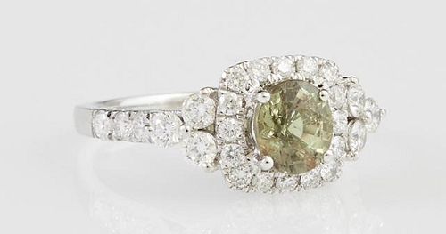 Lady's Platinum Dinner Ring, with a round 1.28 carat alexandrite atop a square border of round diamonds, flanked by diamond m