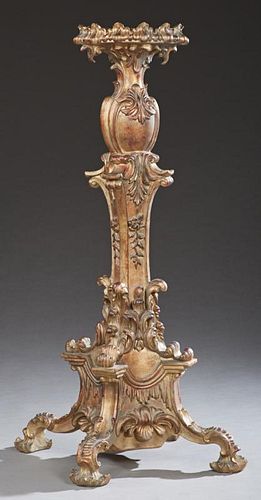French Style Gilt Composition Pedestal, 20th c., the scalloped circular top on bulbous relief support to a tapered relief lea