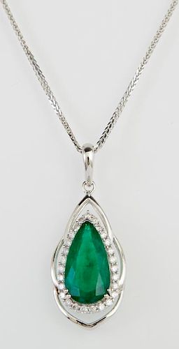 14K White Gold Pendant, with a pear shaped 5.22 carat emerald atop a conforming border of round diamonds within a pierced whi