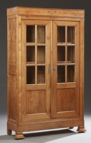 French Carved Cherry Louis Philippe Style Bookcase, 19th c., with a frieze top over two mullioned glazed doors with solid low