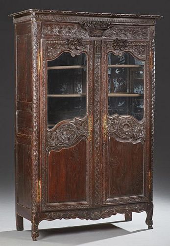 French Louis XV Style Carved Oak Armoire, c. 1860, Brittany, the stepped crown over a central relief carved flowering urn, ab