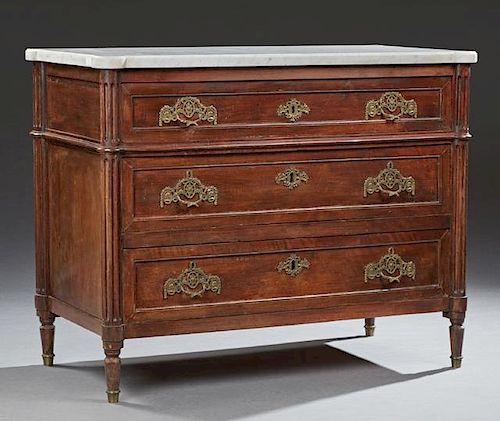 French Louis XVI Style Carved Walnut Marble Top Commode, 19th c., the stepped cookie corner highly figured white marble over 