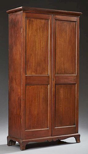 American Federal Style Carved Mahogany Armoire, 19th c., the stepped ogee crown over two double paneled doors, on a plinth ba