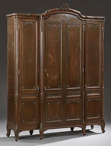 Large French Louis XV Style Carved Walnut Armoire, 19th c., the pierced ribbon crest on an arched crown over a large center d