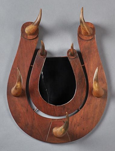 Carved Mahogany Hall Rack, c. 1900, of horseshoe form, with five cowhorn hat holders around a central horseshoe shaped mirror