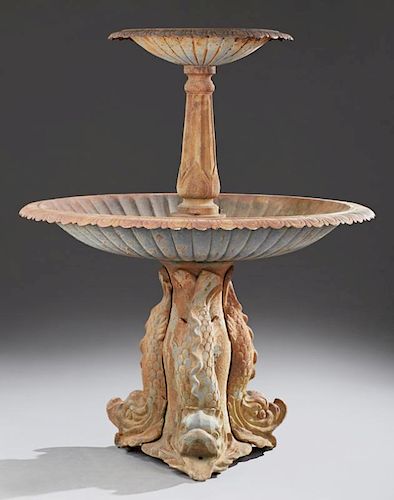 Cast Iron Two Tier Fountain, late 20th c., the scalloped tiers on a tripodal dolphin fish base H.- 54 in., Dia.- 44 in.