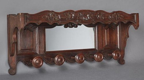 French Carved Oak Hat Rack, early 20th c., the top shelf with a scalloped skirt over a shaped mirror flanked by arched fielde
