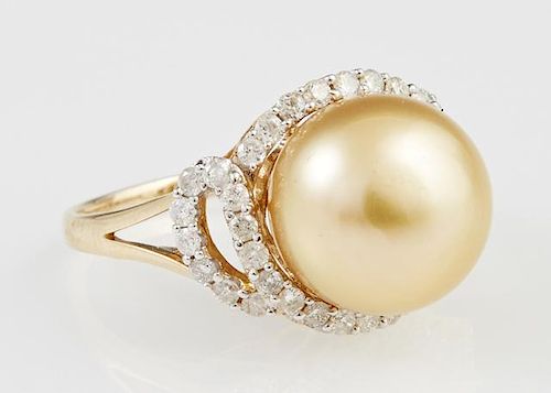 Lady's 18K Yellow Gold Dinner Ring, with a 13 mm golden south seas pearl, atop a pierced border of round diamonds, on a pierc