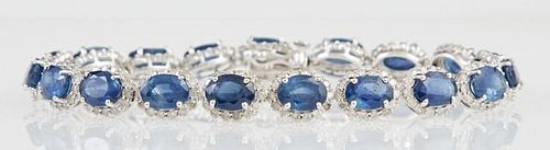 14K White Gold Link Bracelet, each of the 19 oval links with an oval blue sapphire atop a border of round diamonds, total sap