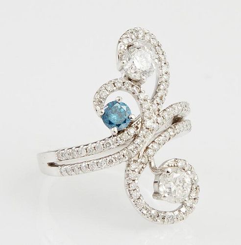 Lady's 14K White Gold Dinner Ring, the pierced swirled top with a central .22 carat blue diamond, flanked by swirling white d