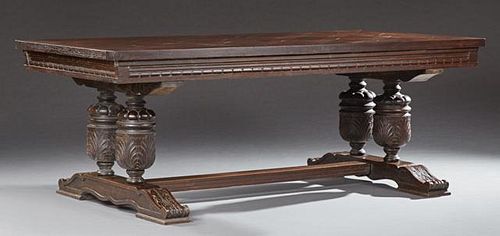 French Louis XIII Style Carved Oak Dining Table, c. 1900, the thick parquetry inlaid top over a carved skirt on large urn sup