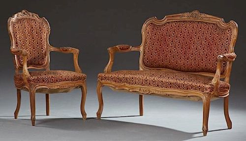 Two Piece French Louis XV Style Carved Walnut Parlor Suite, early 20th c., consisting of a settee and a fauteuil, the arched 