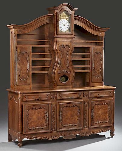 French Provincial Carved Walnut and Cherry Louis XV Style Vaisselier, 19th c., the superstructure centered with a clock, time