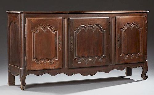 French Louis XV Style Carved Walnut Sideboard, late 19th c., the rounded edge and corner rectangular top over three fielded p