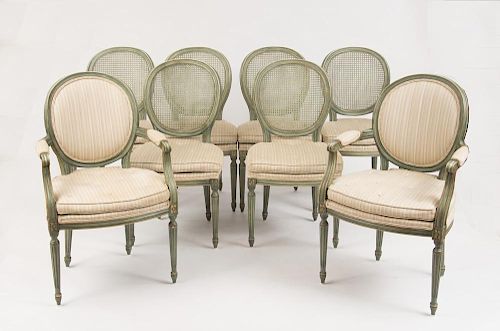 EIGHT LOUIS XVI STYLE GREEN PAINTED AND CANED DINING CHAIRS